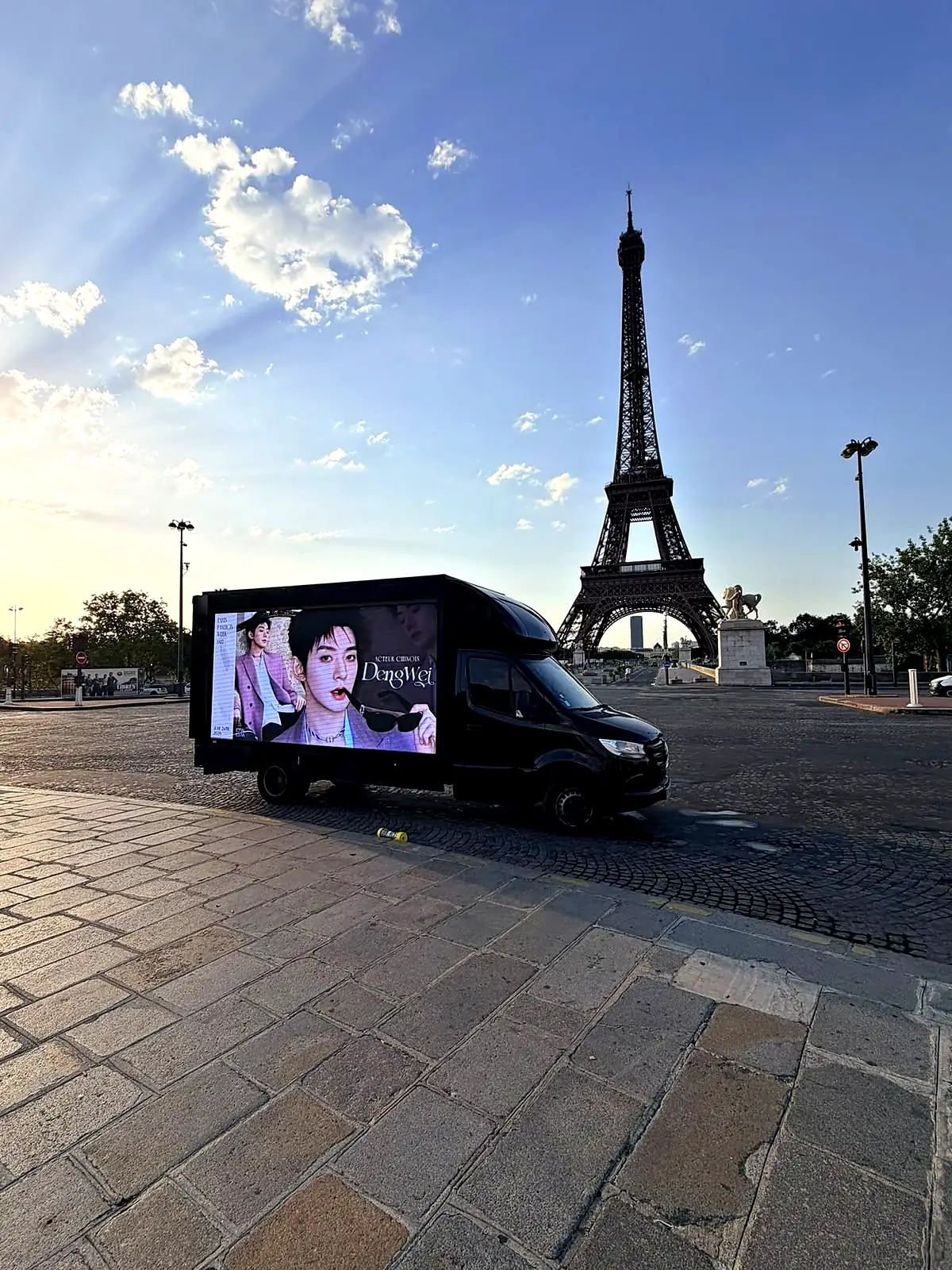 Camion LED au pont d'Iéna face à la tour Eiffel, à l'aube